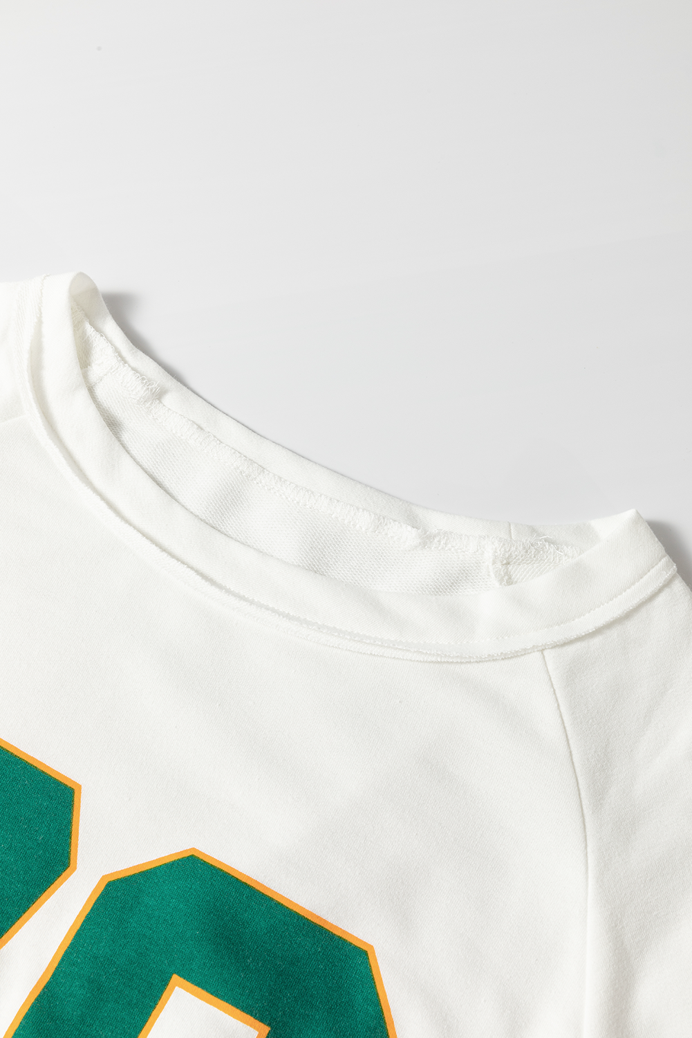 View of round neck on Number 76 Round Neck Long Sleeve Top