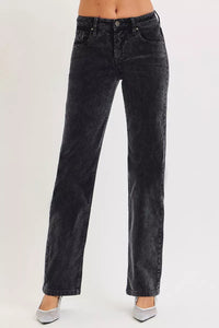 Black jeans worn by a person on a white background