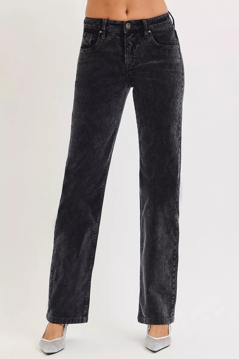 Black jeans worn by a person on a white background