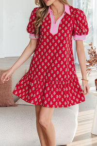 Woman wearing a red floral dress in a living room setting
