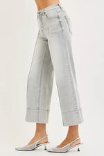 Light gray jeans worn by a person on a white background