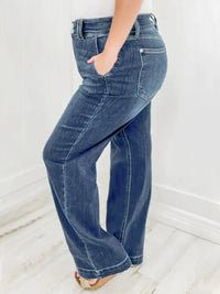 Blue jeans worn by a person on a white background