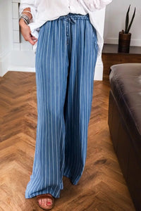 Person wearing blue striped pants in a living room setting