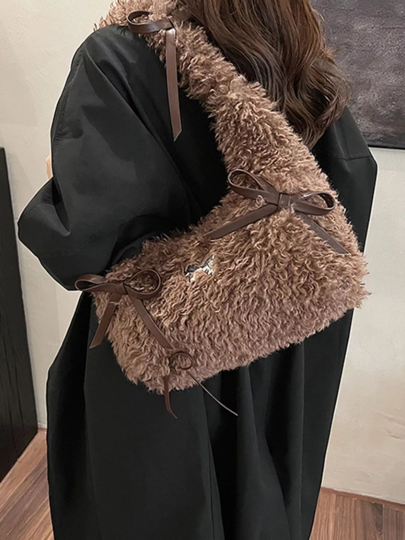 Black coat with brown fur collar and trim on a neutral background