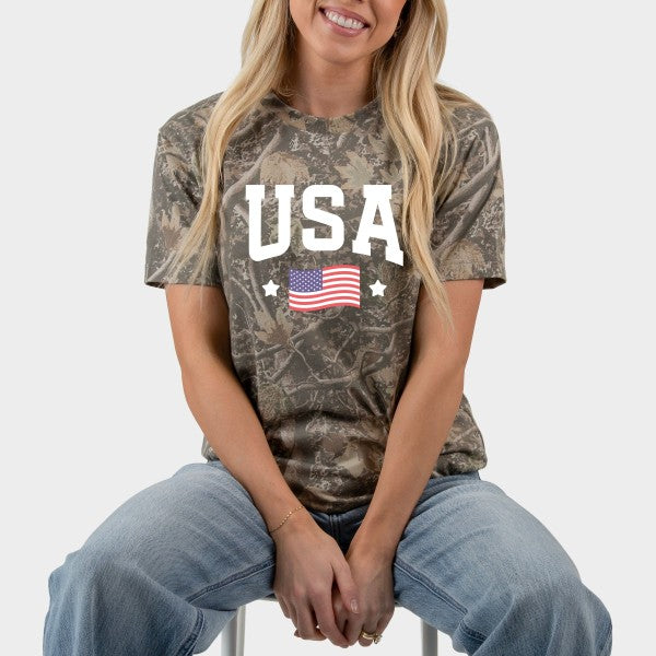Person wearing a camouflage t-shirt with 'USA' and an American flag design.