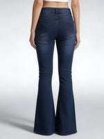 Navy blue flared jeans worn by a person on a white background