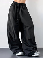 Black wide-leg pants worn by a person on a plain background