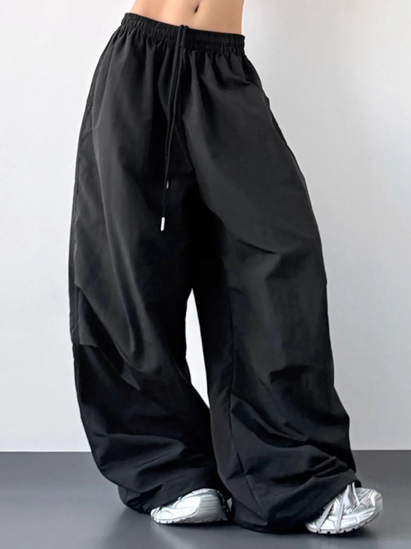 Black wide-leg pants worn by a person on a plain background