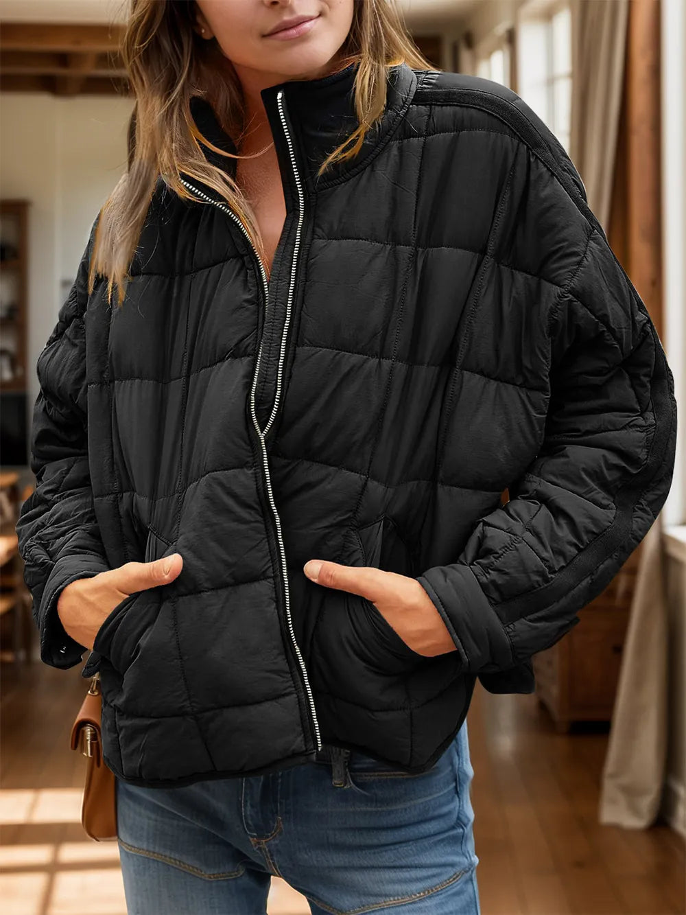 Person wearing a black puffer jacket indoors