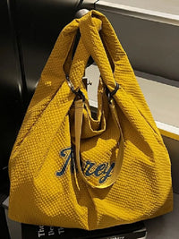 Yellow textured handbag with 'Ferry' branding on a dark surface