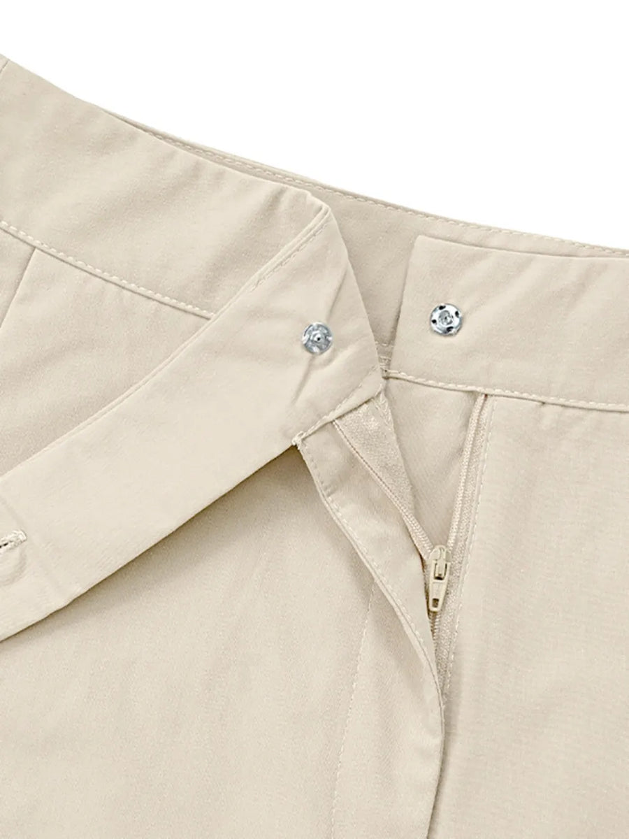 Close-up of a beige shirt with collar and button details on a white background