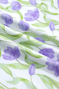 Pattern of purple tulips and green leaves on a white background