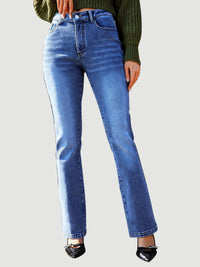 Blue jeans worn by a person on a light gray background