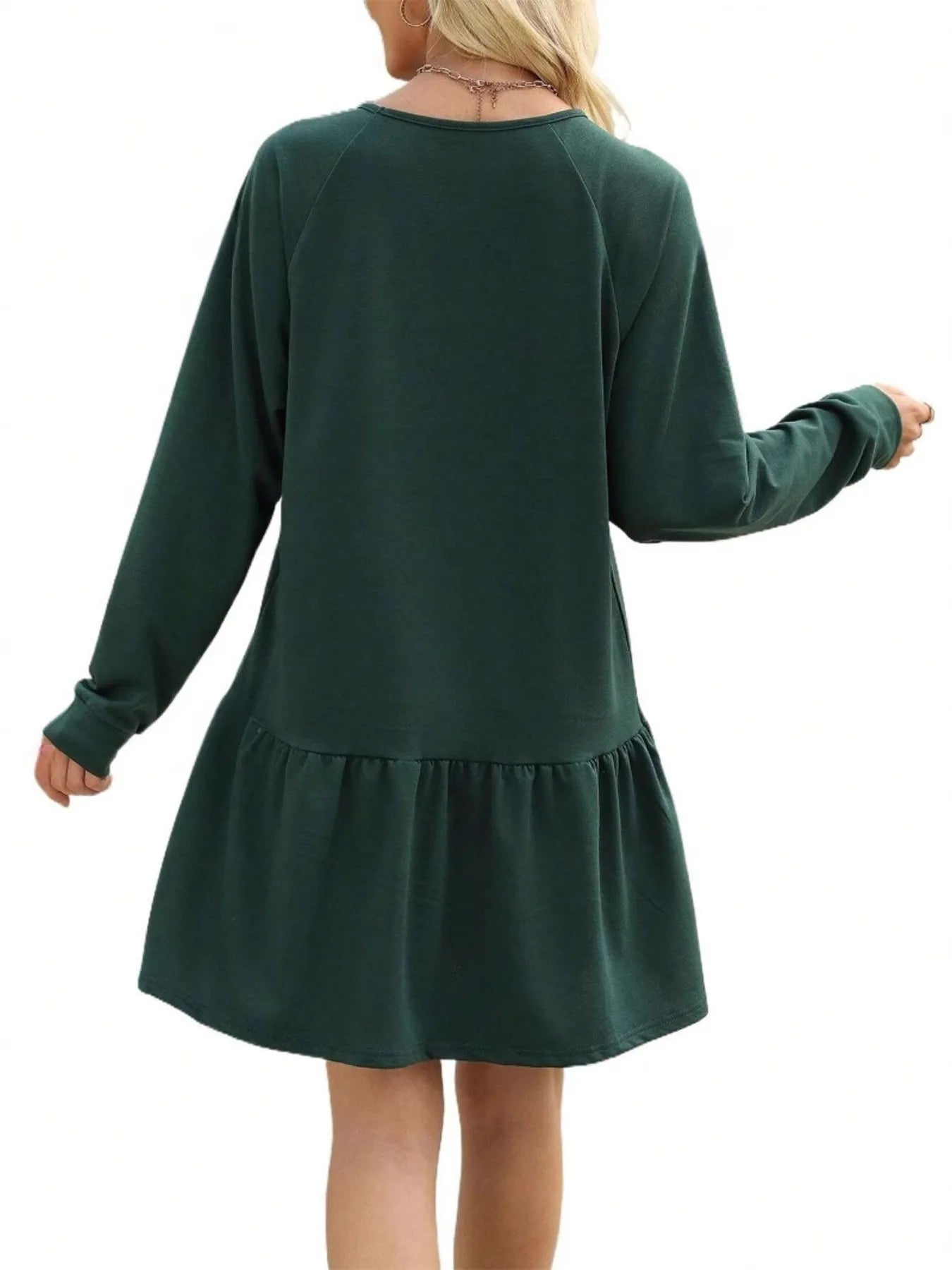 Green dress with long sleeves and a skirt on a white background