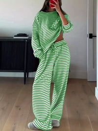 Person wearing a green and white striped outfit in a room.