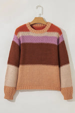 Color-blocked sweater on a hanger against a white background