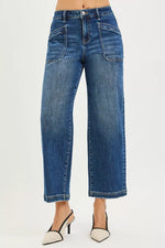 Blue jeans worn by a person on a white background