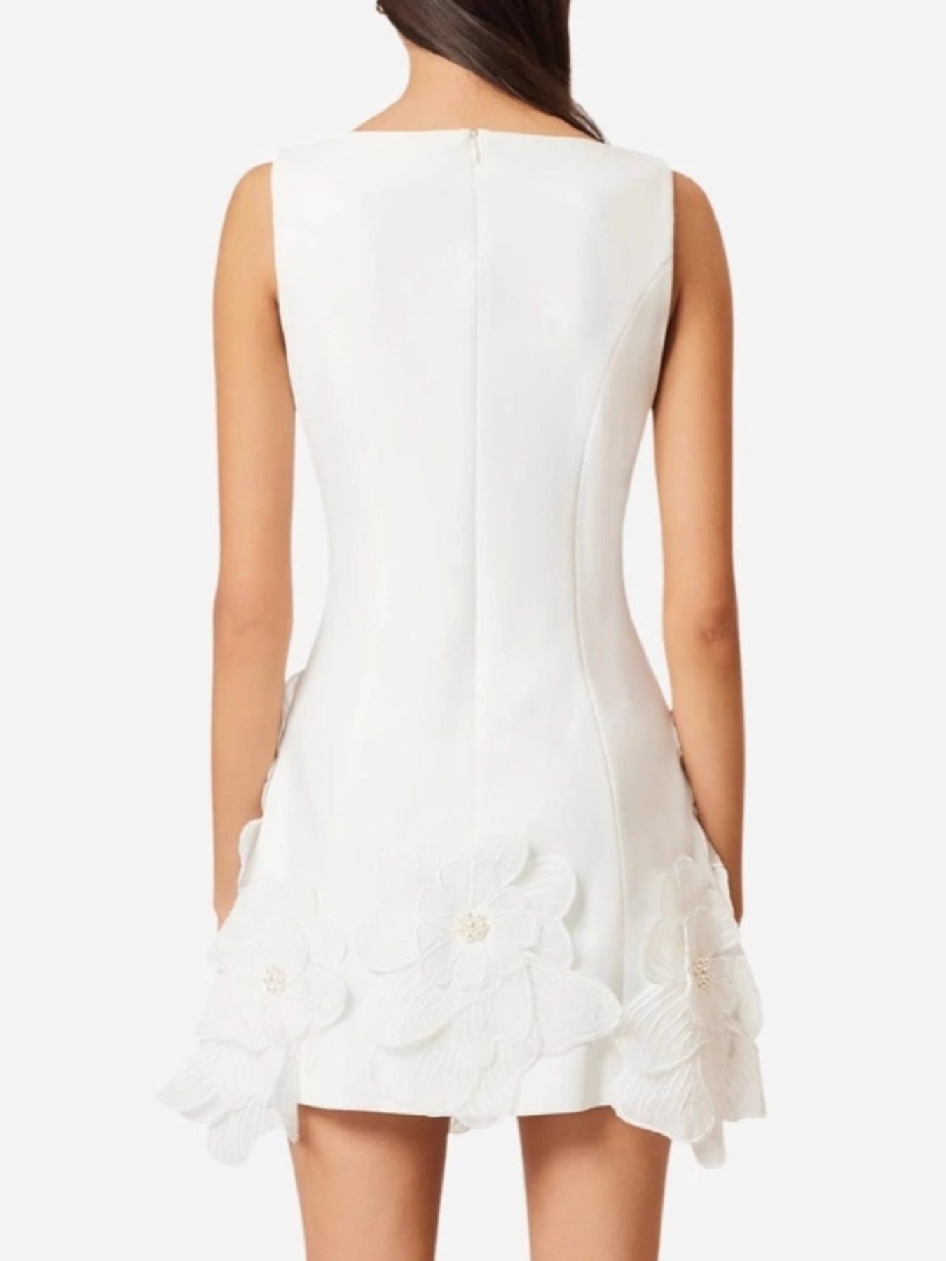White sleeveless dress with floral details on a white background