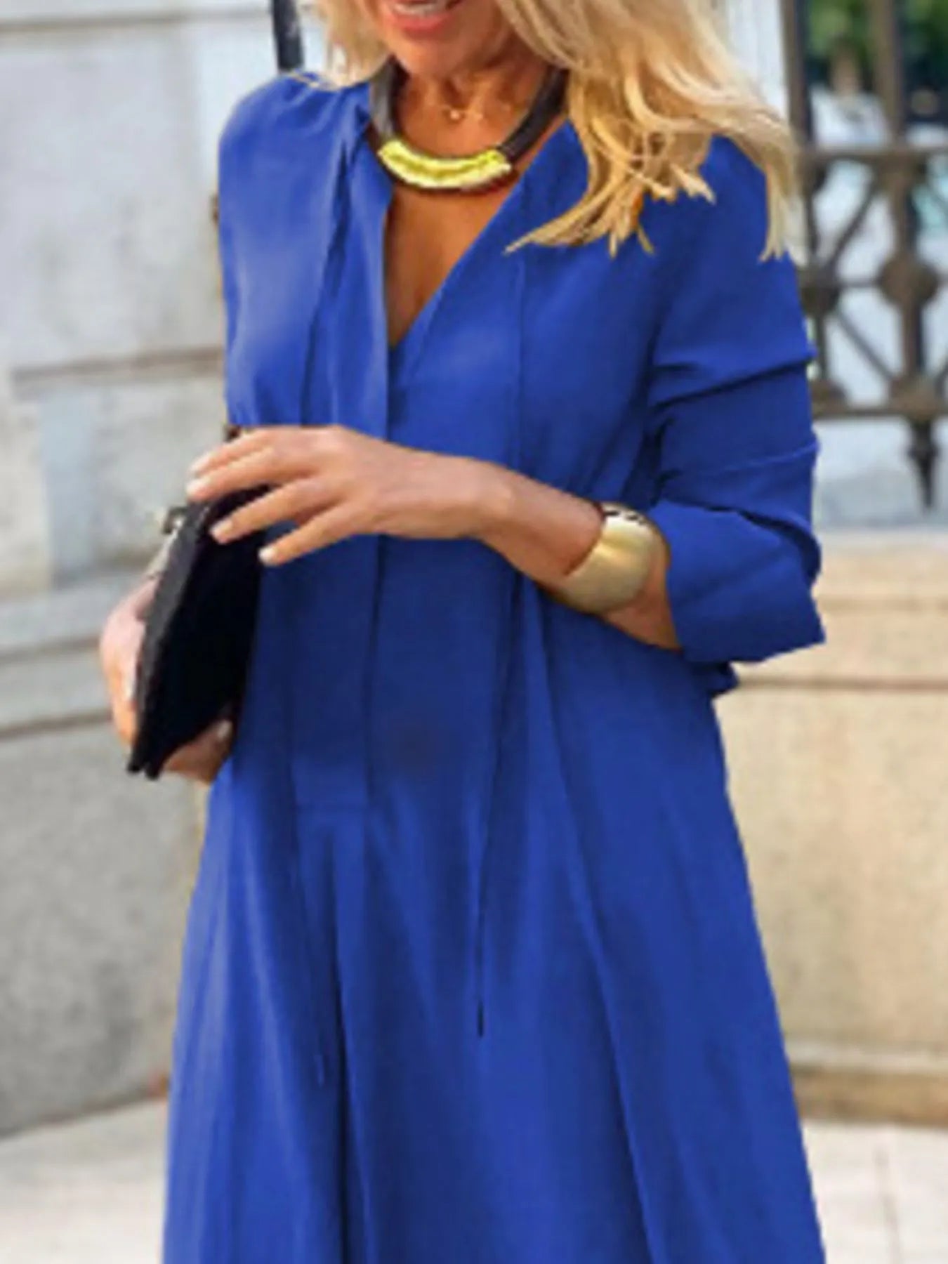 Person wearing a blue dress with a blurred background