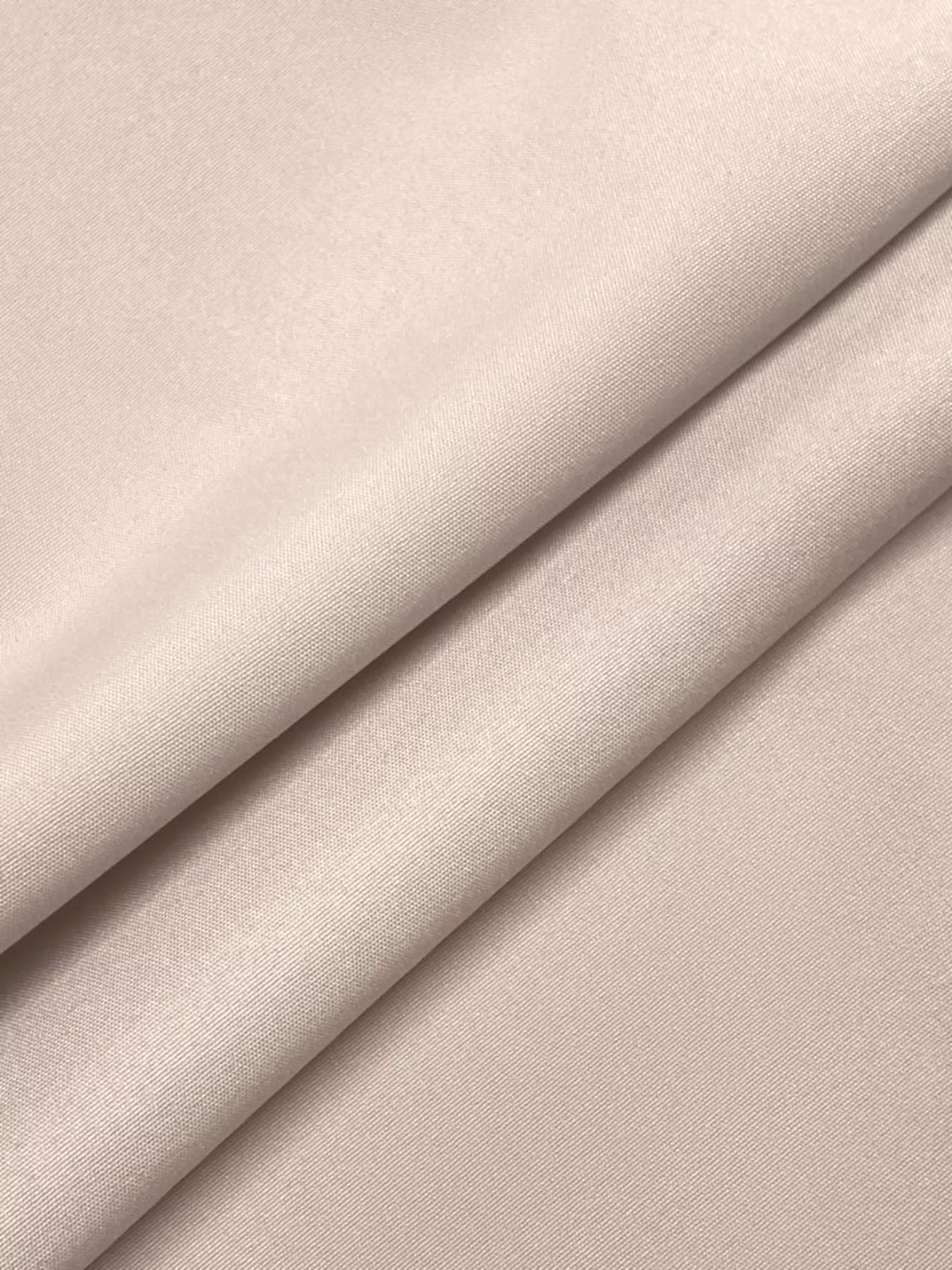 Close-up of beige fabric with a subtle texture