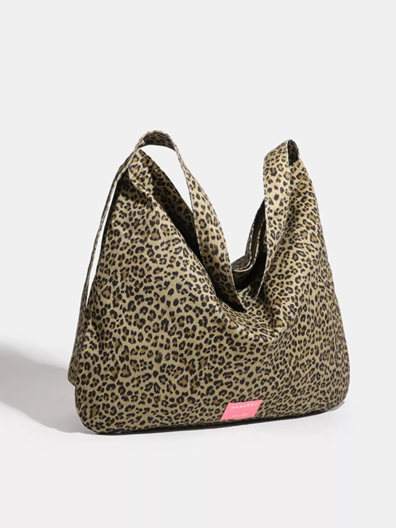 Leopard print bag with a pink tag on a white background