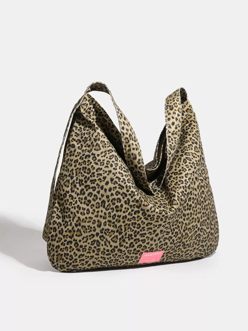 Leopard print bag with a pink tag on a white background