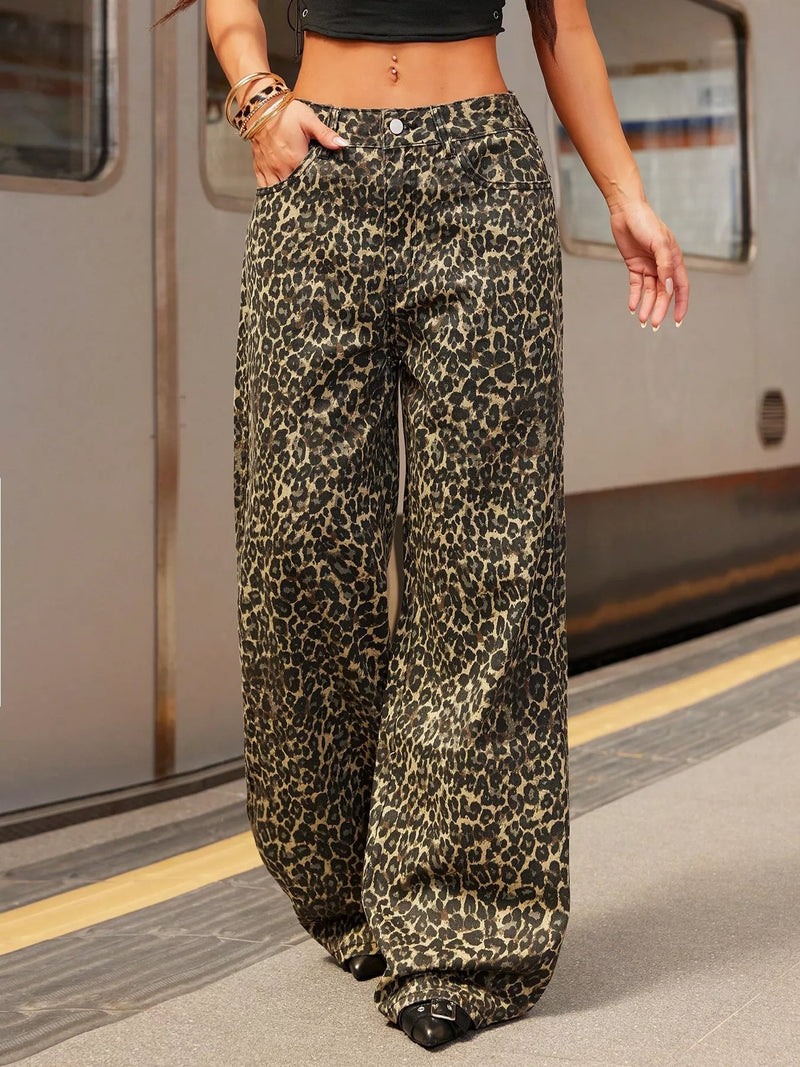 Person wearing leopard print pants on a train platform