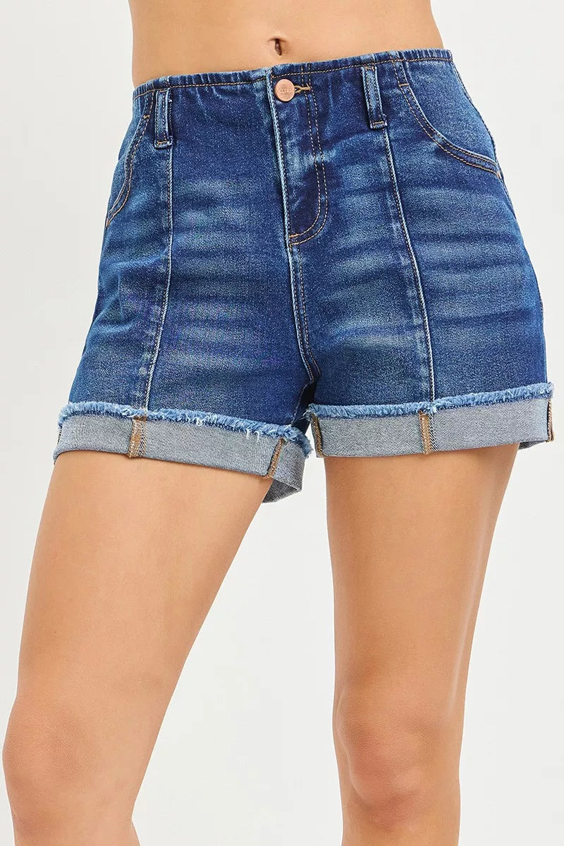 Blue denim shorts with rolled-up hem on a white background