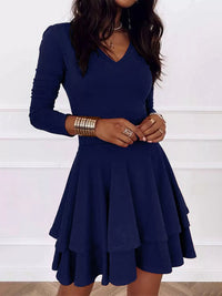 Navy blue dress worn by a person on a white background