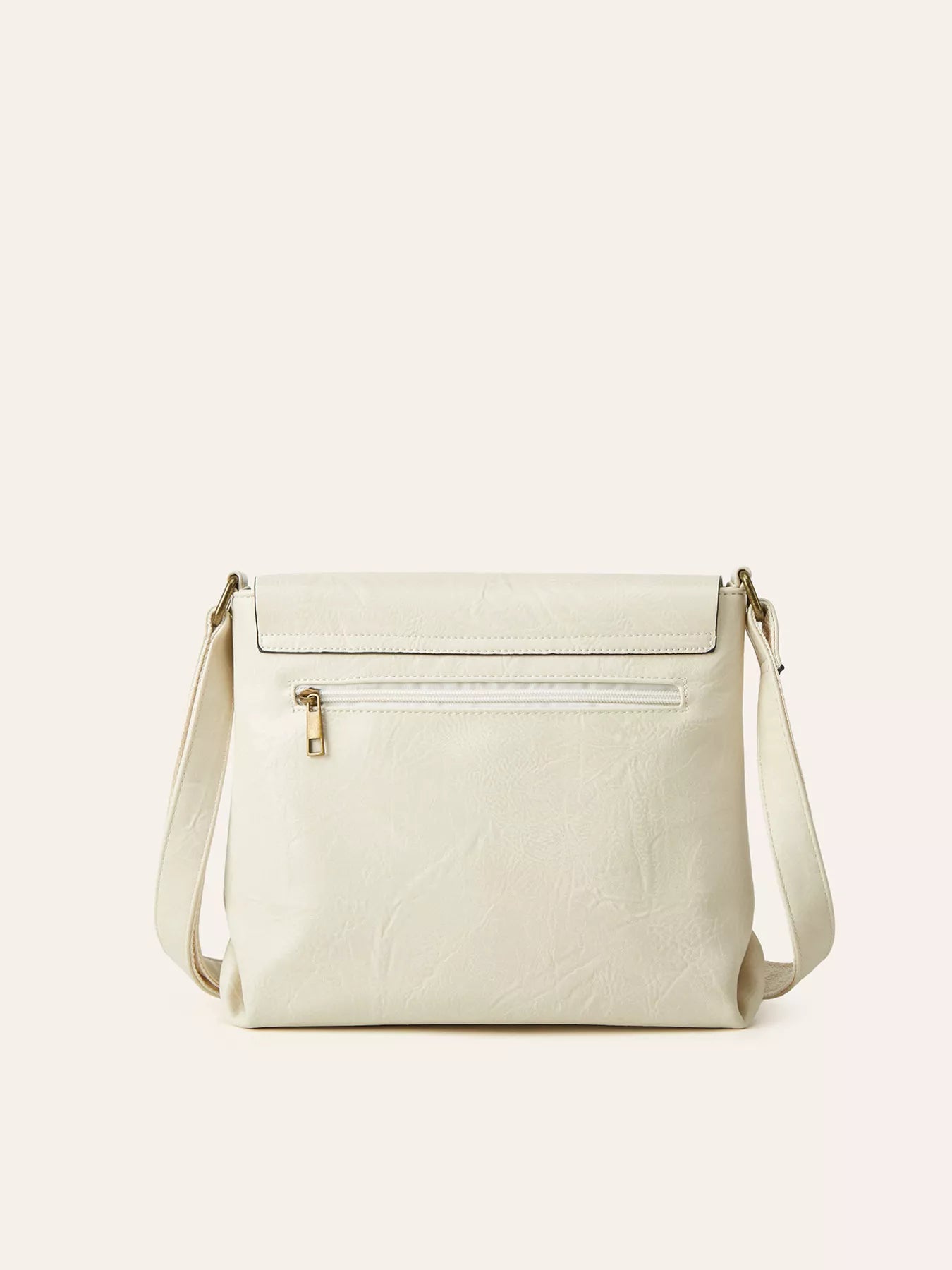 Beige handbag with a gold zipper on a light beige background