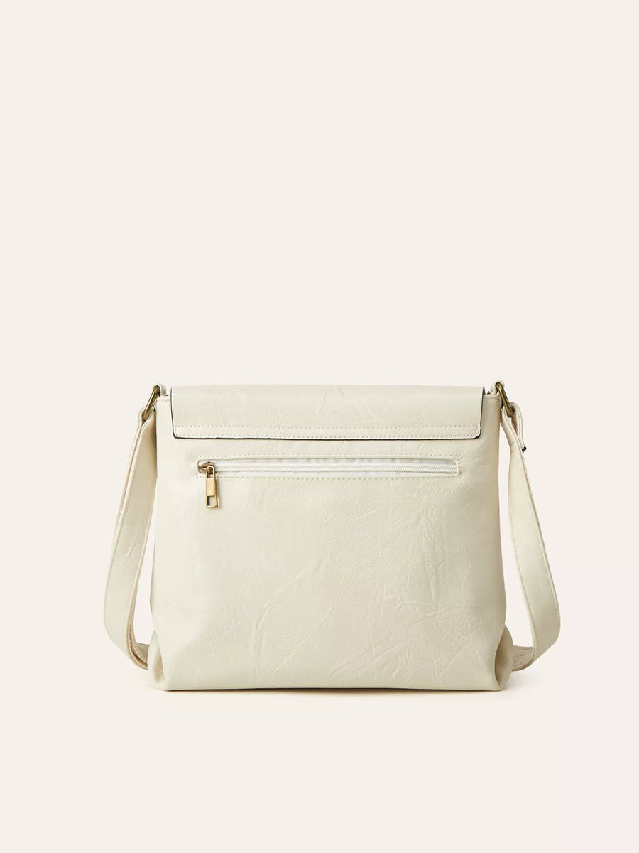 Beige handbag with a gold zipper on a light beige background