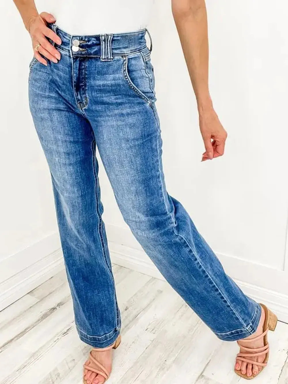 Person wearing blue jeans on a white background