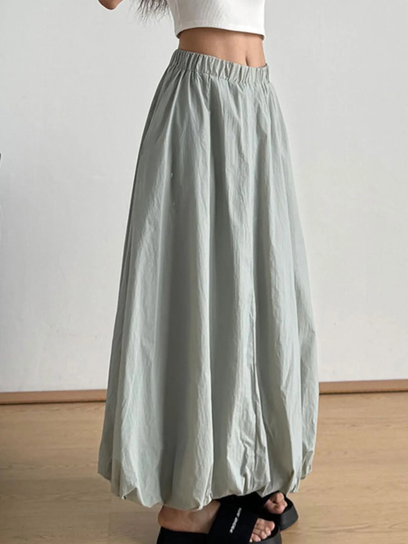 Light green skirt worn by a person on a plain background