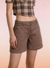 Person wearing brown shorts and a plaid shirt on a gradient background