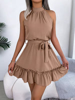 Woman wearing a beige dress with a white background