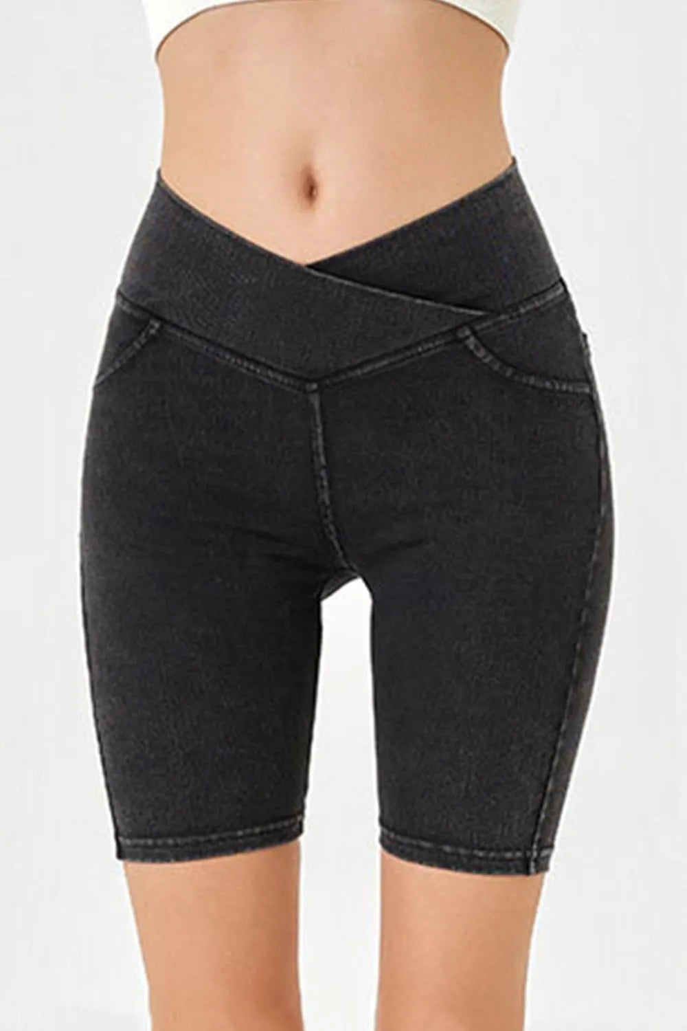 Black denim shorts on a white background