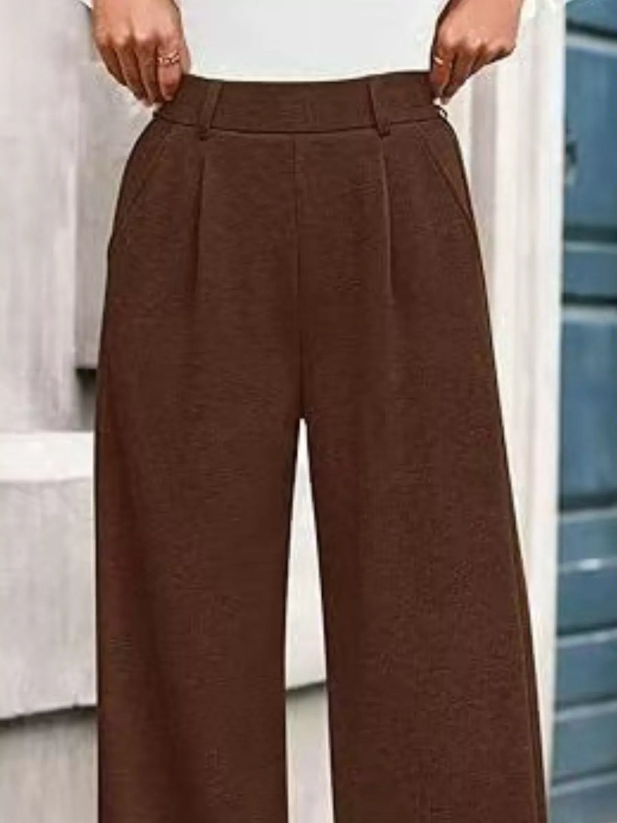 Brown wide-leg pants worn by a person, with a blurred background.