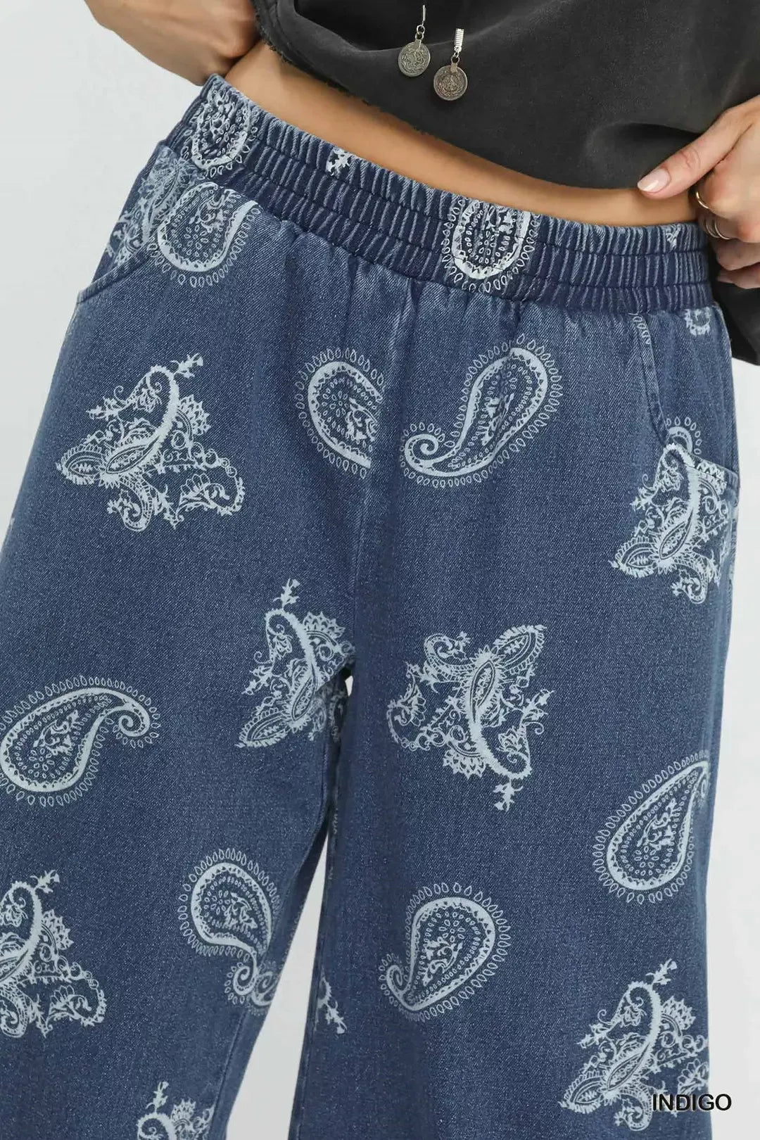 Blue paisley-patterned pants on a white background