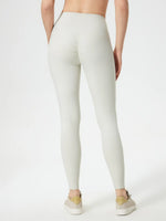 Person wearing light gray leggings on a white background