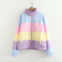 Pastel striped jacket on a hanger against a white background