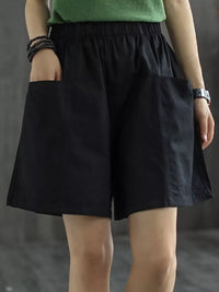 Person wearing black shorts with a blurred background