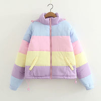 Pastel striped jacket on a hanger against a white background
