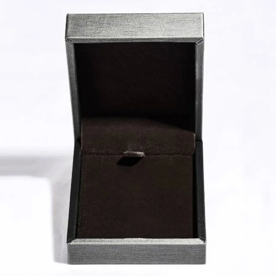 Black jewelry box with a silver lid on a white background