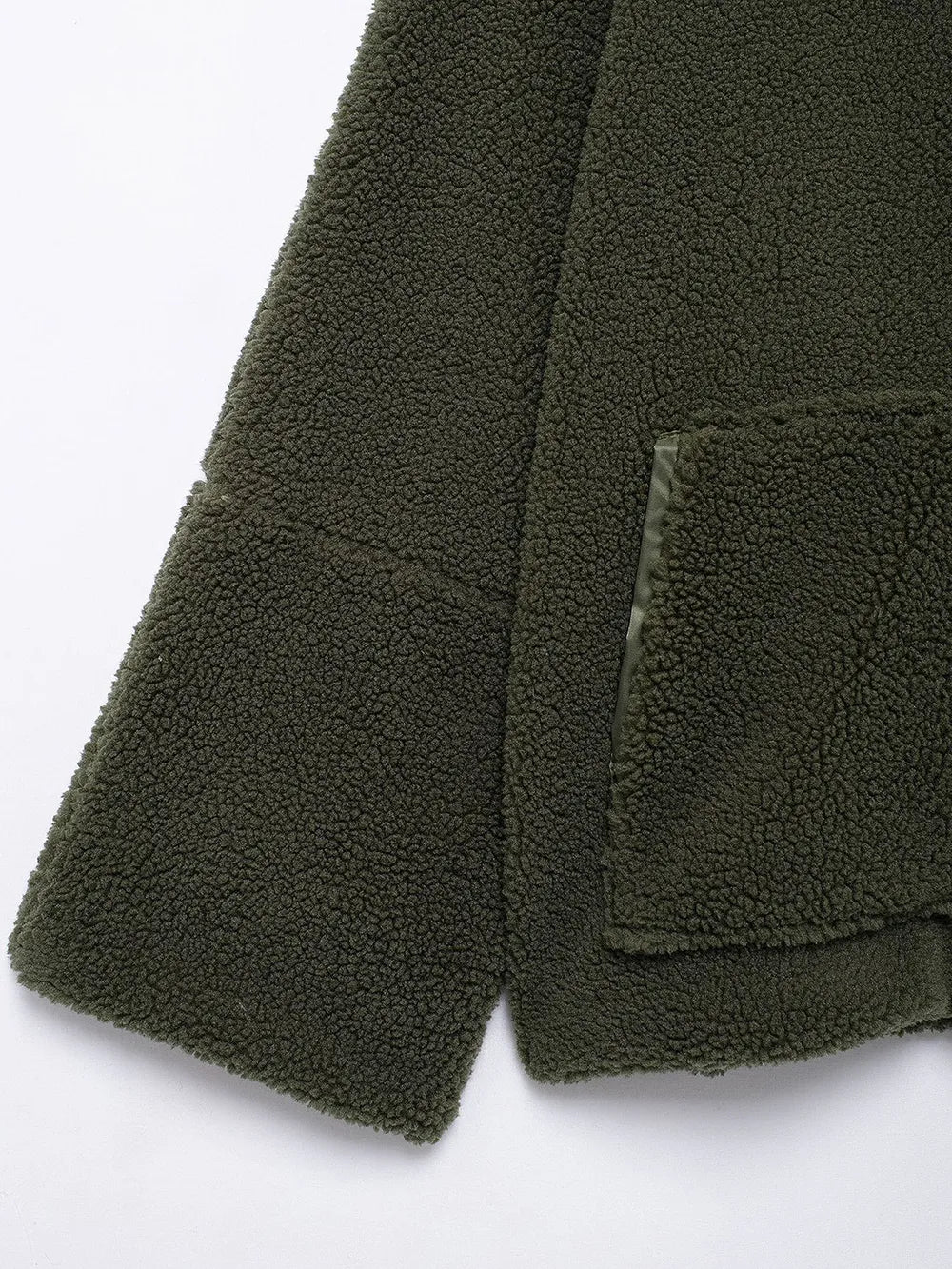 Close-up of a green fleece jacket with a pocket on a white background