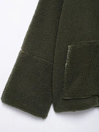 Close-up of a green fleece jacket with a pocket on a white background