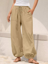 Beige wide-leg pants worn by a person on a light background