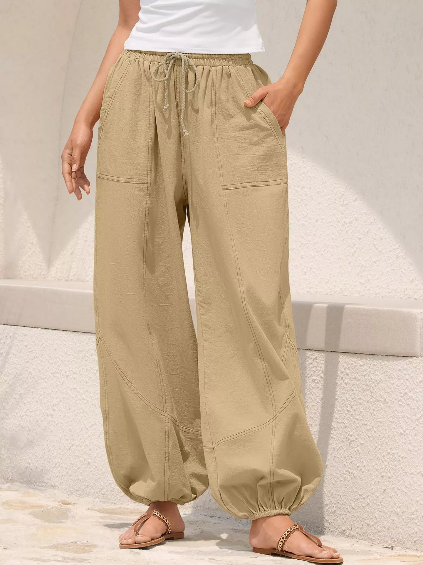 Beige wide-leg pants worn by a person on a light background