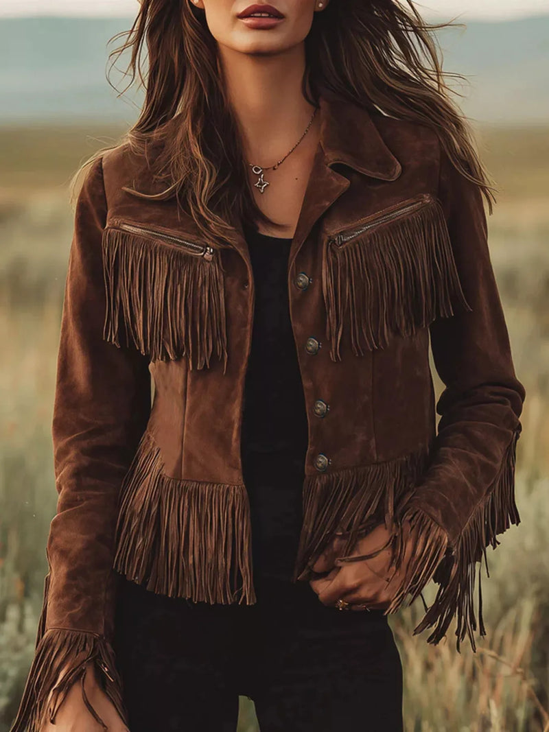 Brown suede jacket with fringes worn by a person in a field