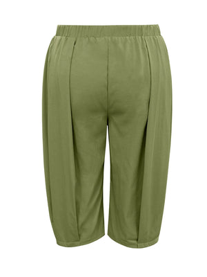 Green capri pants on a white background