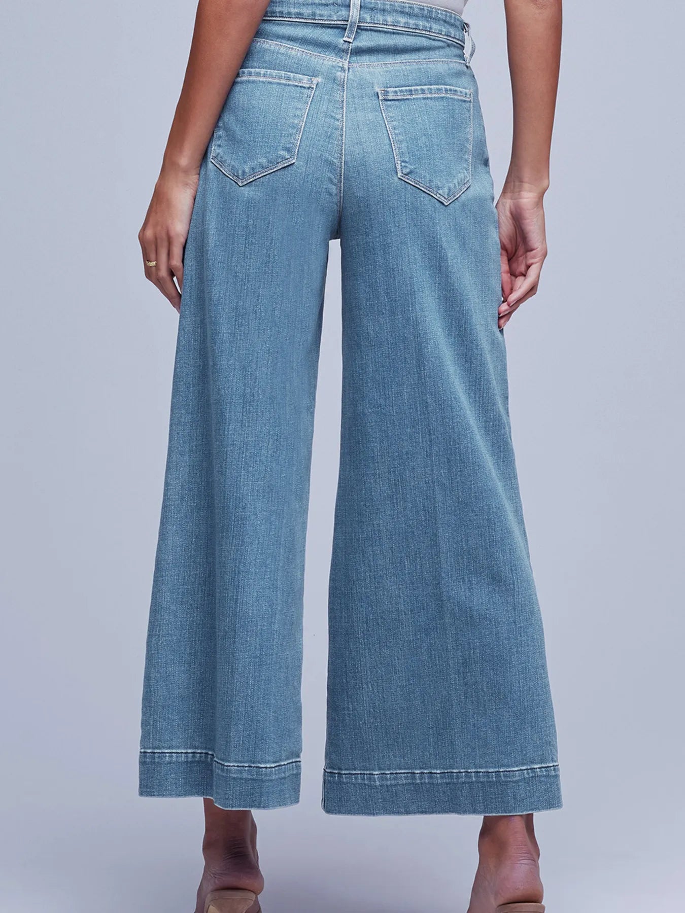 Blue denim wide-leg jeans on a plain background